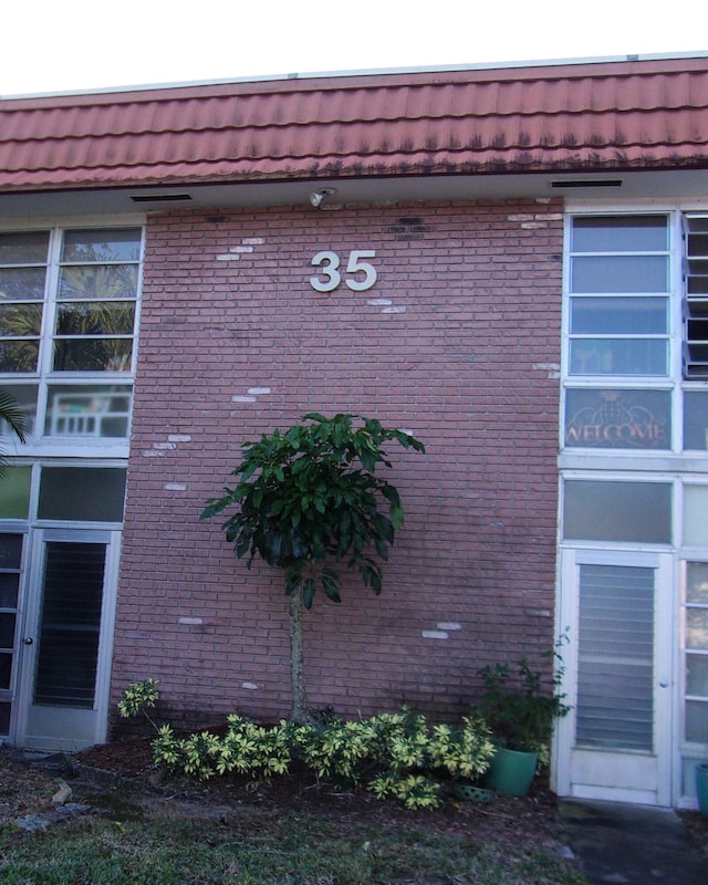 1225 NW 21st St Unit 3506, Stuart, FL 34994 - view of property exterior featuring brick siding and mansard roof