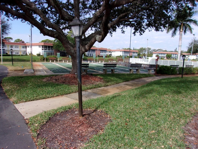 view of home's community with a lawn