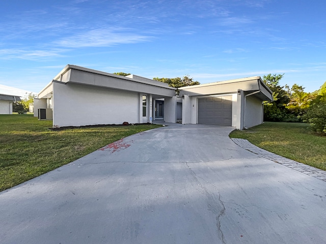 view of front of home featuring a garage and a front lawn