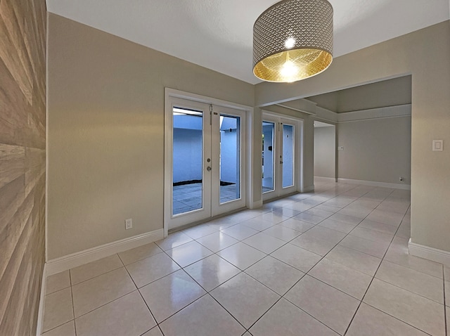 tiled empty room featuring french doors