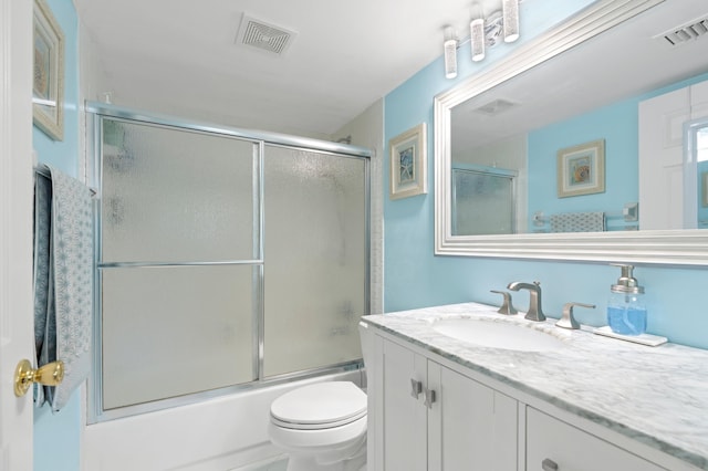 full bathroom with vanity, combined bath / shower with glass door, and toilet