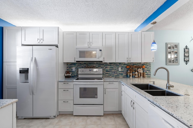 kitchen with a textured ceiling, white appliances, sink, decorative light fixtures, and white cabinetry