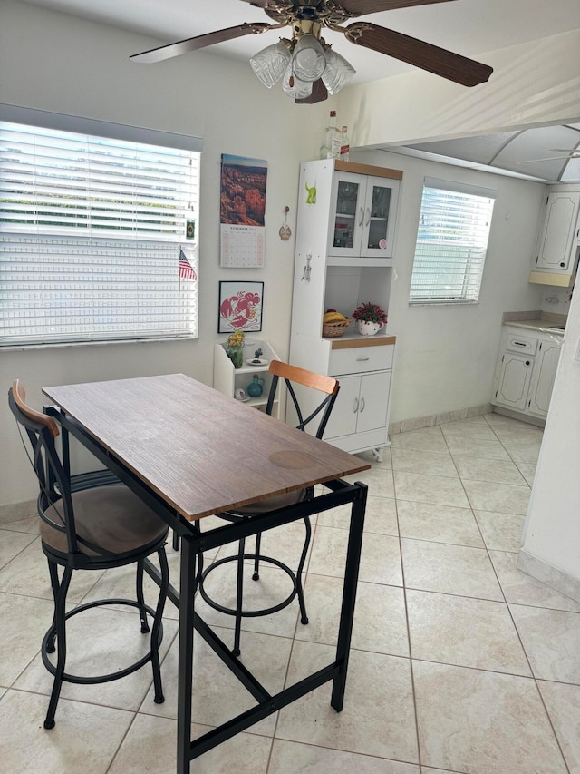 dining area with ceiling fan, plenty of natural light, and light tile patterned flooring