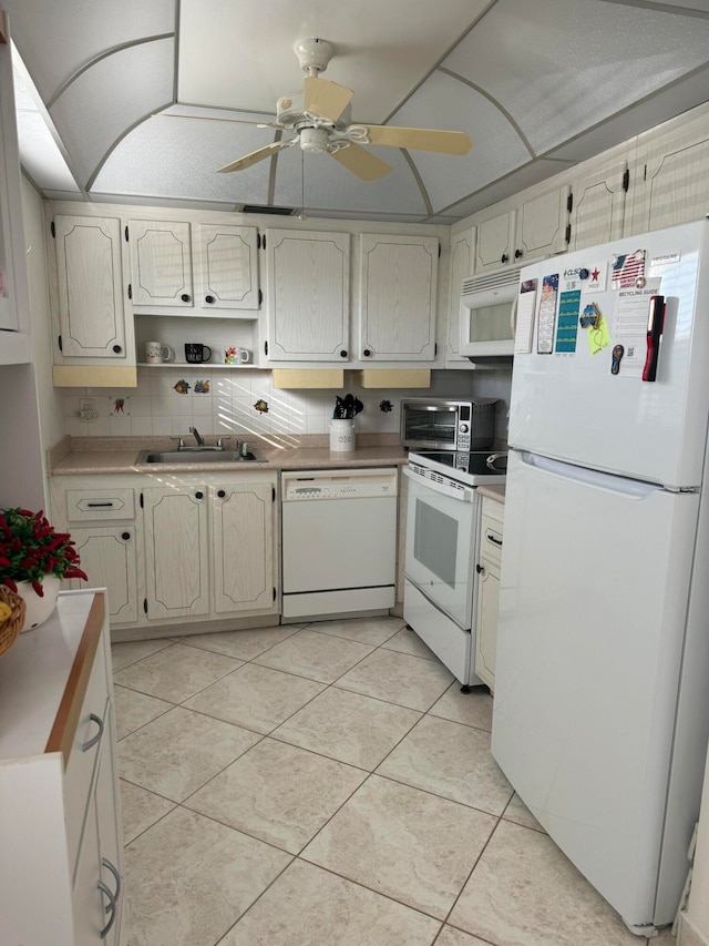 kitchen with white appliances, backsplash, sink, ceiling fan, and light tile patterned flooring