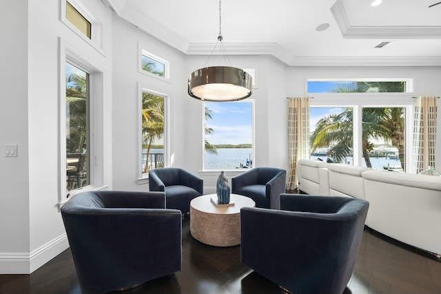 sunroom / solarium featuring a water view