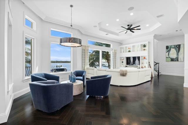 living room featuring ceiling fan, dark parquet flooring, ornamental molding, and a wealth of natural light