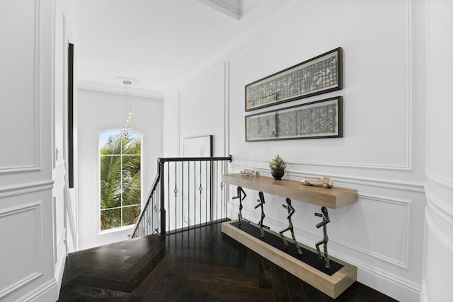 corridor with crown molding and parquet flooring