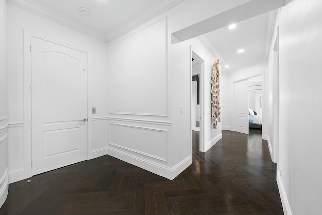 hall featuring dark parquet flooring and ornamental molding