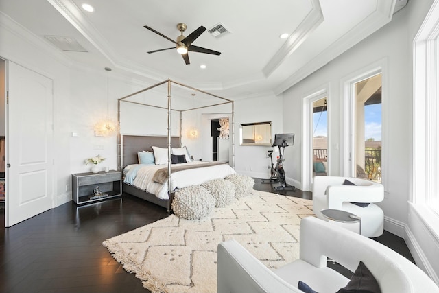 bedroom with a raised ceiling, ceiling fan, dark wood-type flooring, and ornamental molding