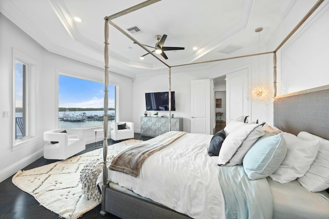 bedroom with a raised ceiling, ceiling fan, ornamental molding, and hardwood / wood-style flooring