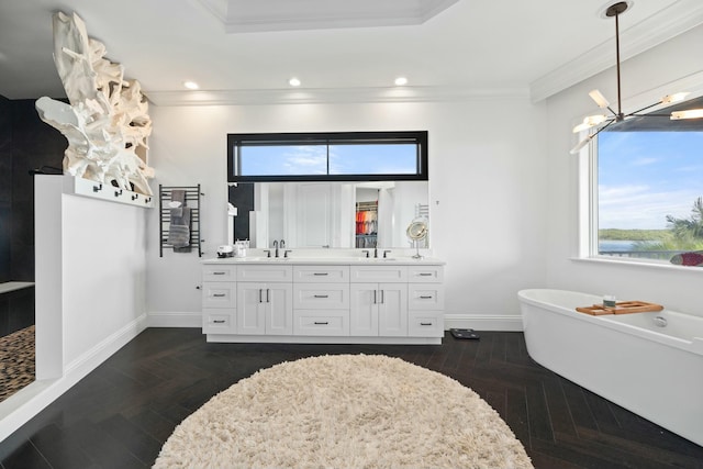 bathroom featuring vanity, parquet floors, crown molding, and a washtub