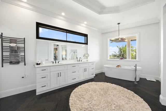 bathroom with a wealth of natural light, a washtub, vanity, and ornamental molding