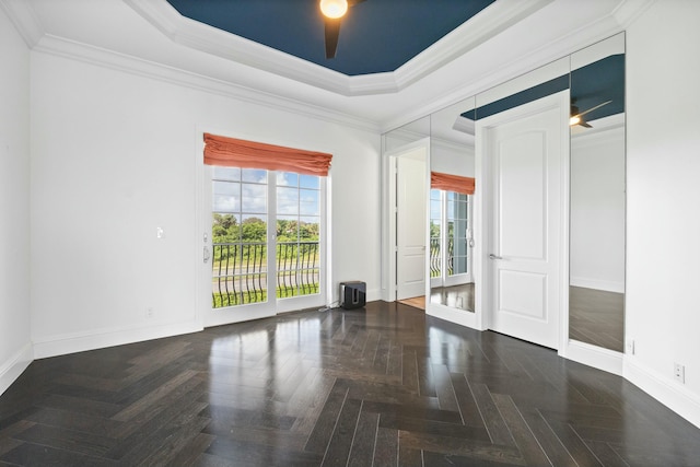 unfurnished room with dark parquet floors, ceiling fan, and crown molding