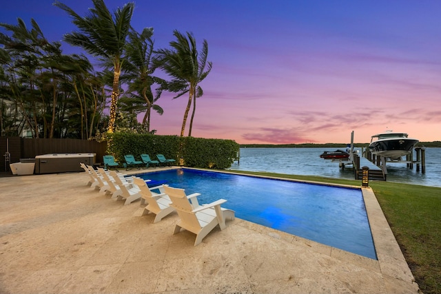 pool at dusk with a boat dock, a water view, and a hot tub