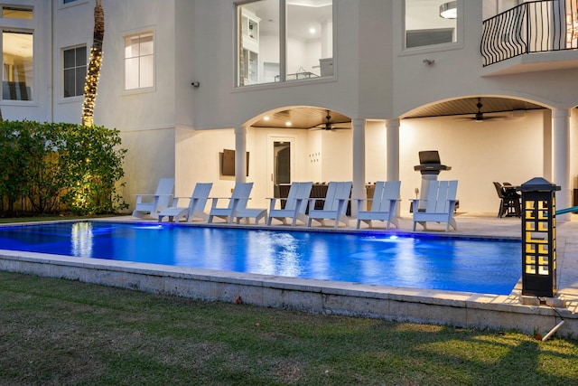 view of pool with a patio and ceiling fan