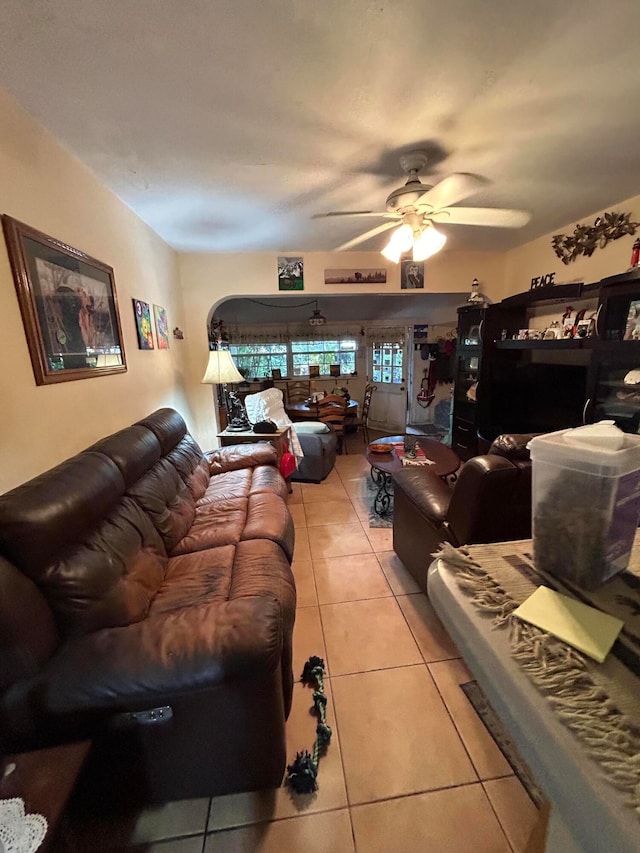 tiled living room with ceiling fan