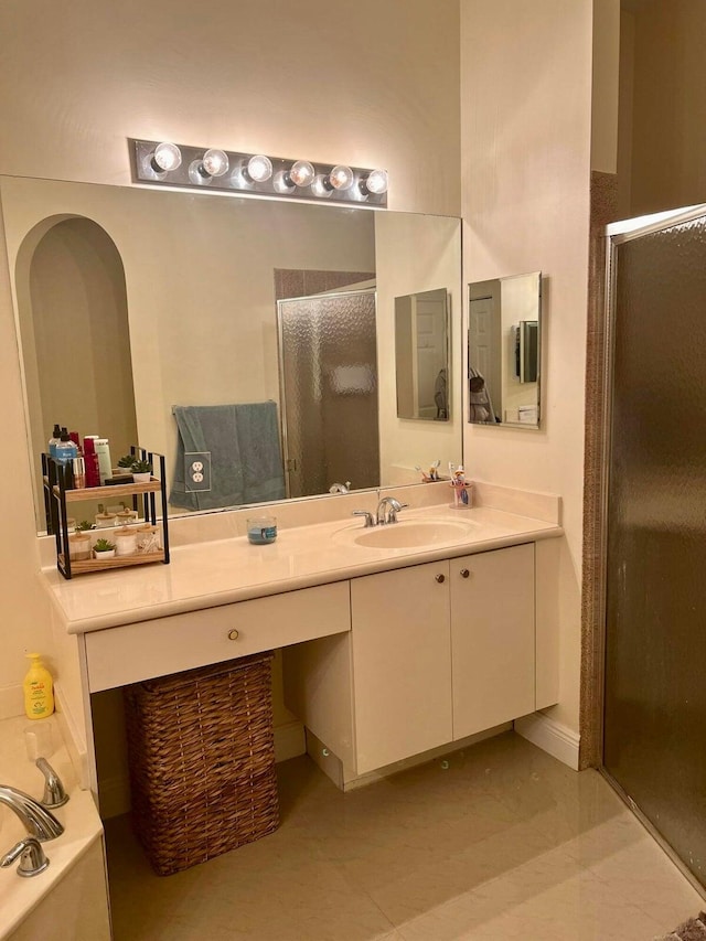 bathroom with vanity and shower with separate bathtub