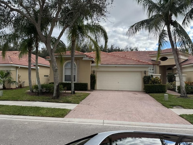 mediterranean / spanish-style home with a garage