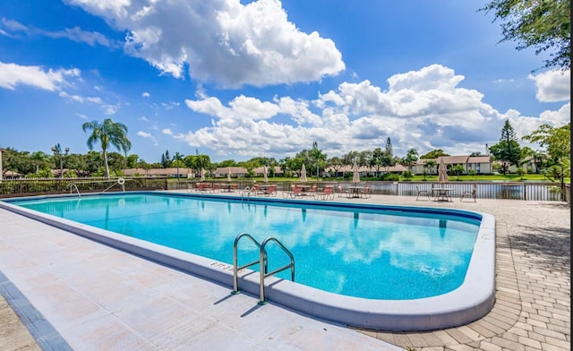 view of swimming pool with a water view