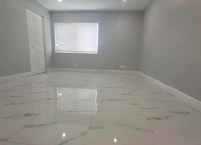 unfurnished room with a textured ceiling