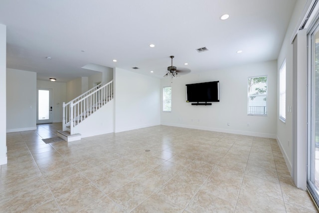 unfurnished living room featuring ceiling fan and light tile patterned floors