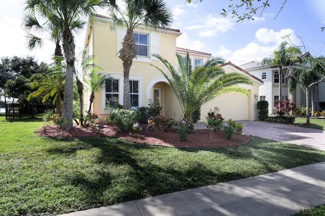 mediterranean / spanish-style house featuring a garage and a front yard