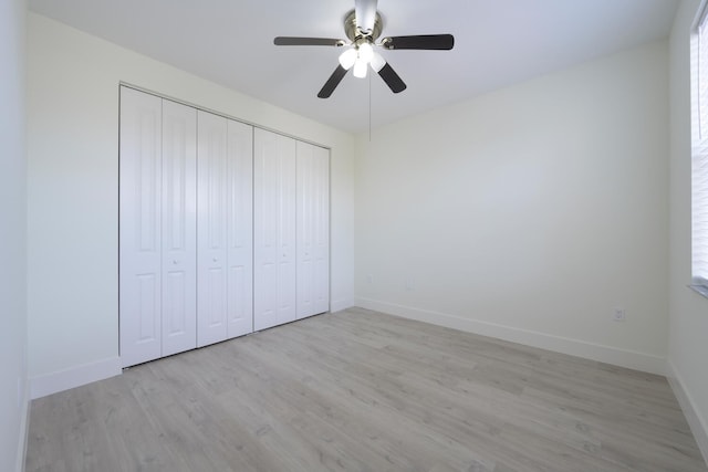 unfurnished bedroom featuring light wood-type flooring, a closet, and ceiling fan