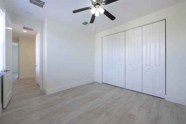 unfurnished bedroom featuring light hardwood / wood-style floors, a closet, and ceiling fan