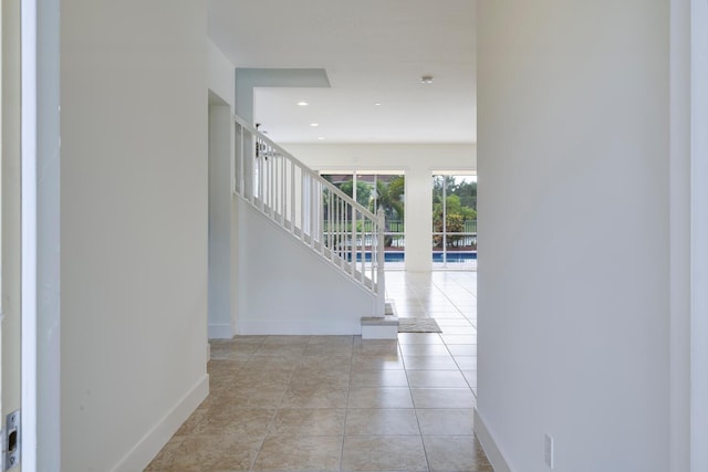 hall featuring light tile patterned floors