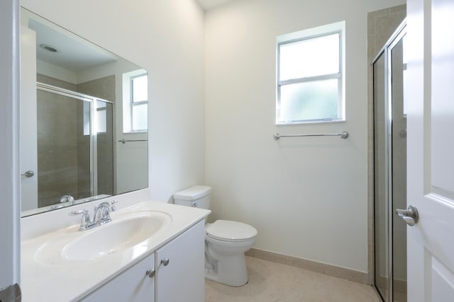 bathroom with tile patterned floors, toilet, vanity, and walk in shower