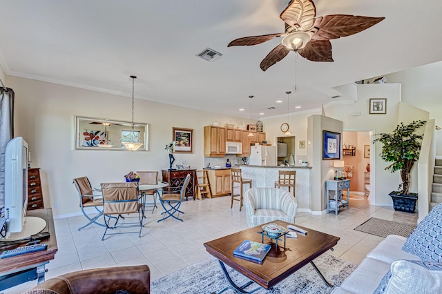 tiled living room featuring ceiling fan and crown molding