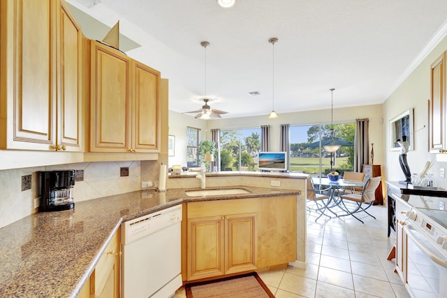 kitchen featuring stove, white dishwasher, sink, hanging light fixtures, and kitchen peninsula