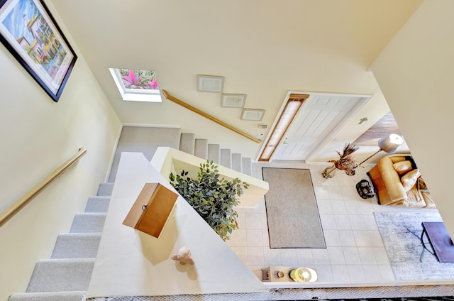 stairway featuring a skylight