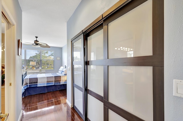 bedroom featuring dark hardwood / wood-style flooring and ceiling fan