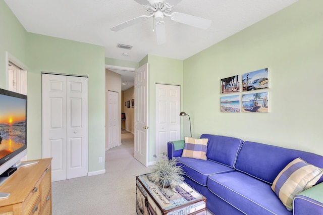 carpeted living room featuring ceiling fan