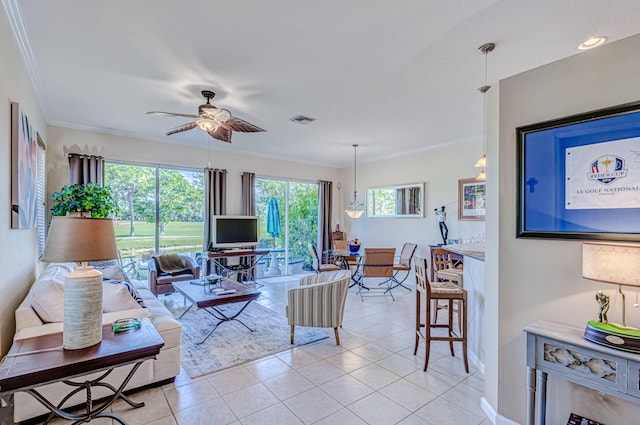 tiled living room featuring ceiling fan and crown molding