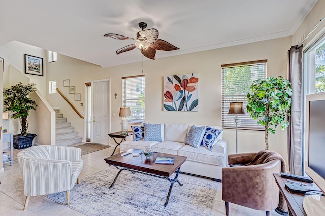 tiled living room featuring a wealth of natural light, crown molding, and ceiling fan