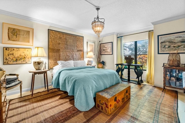 bedroom featuring a textured ceiling, an inviting chandelier, and ornamental molding