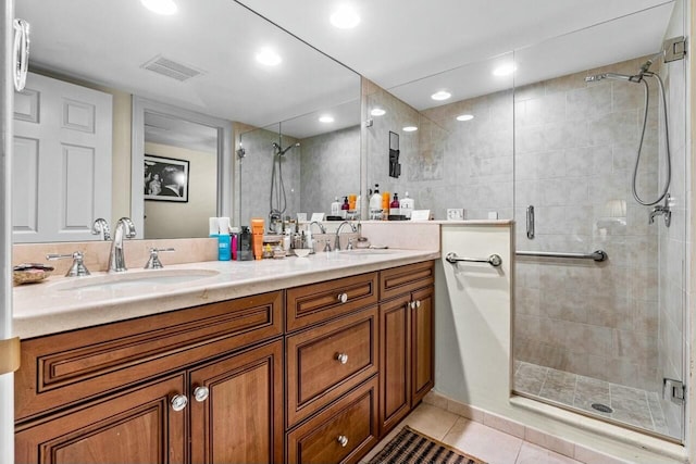 bathroom with tile patterned flooring, vanity, and a shower with shower door