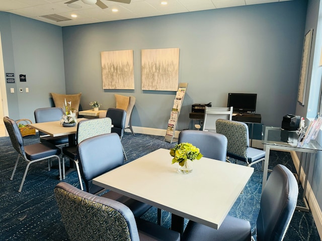 carpeted dining space featuring ceiling fan