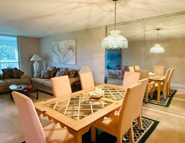 dining space with carpet floors and a notable chandelier