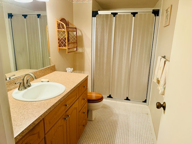 bathroom featuring toilet, vanity, tile patterned floors, and walk in shower