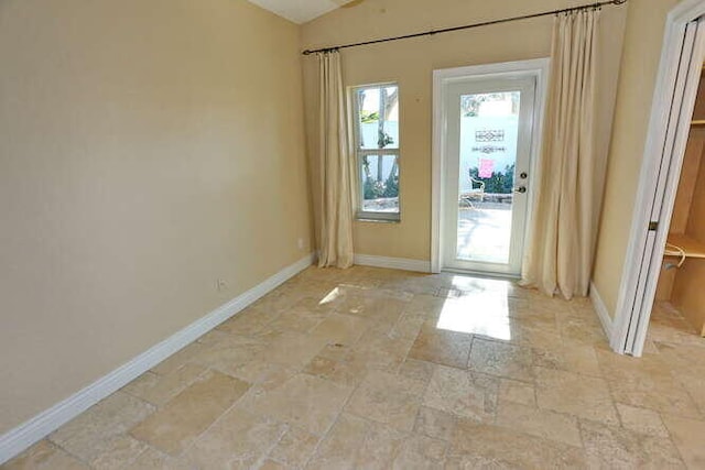 doorway to outside featuring vaulted ceiling