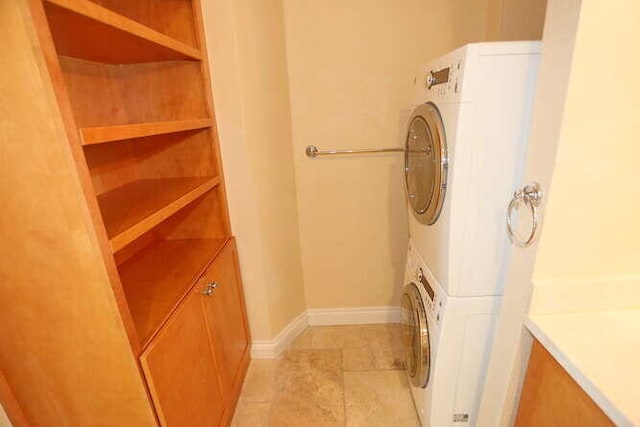 laundry area with stacked washer and clothes dryer