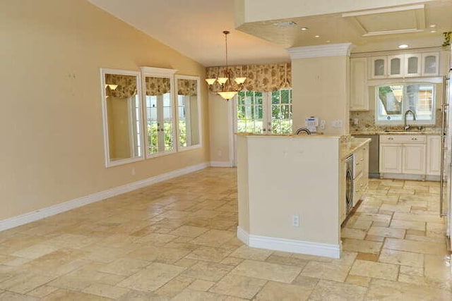 kitchen featuring an inviting chandelier, sink, vaulted ceiling, decorative light fixtures, and washer / dryer