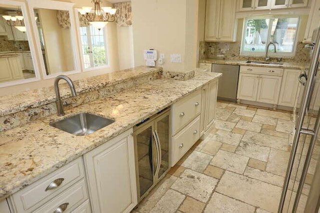 kitchen featuring decorative light fixtures, plenty of natural light, sink, and appliances with stainless steel finishes