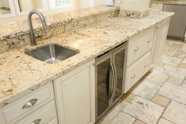 kitchen featuring light stone countertops, sink, and stainless steel appliances