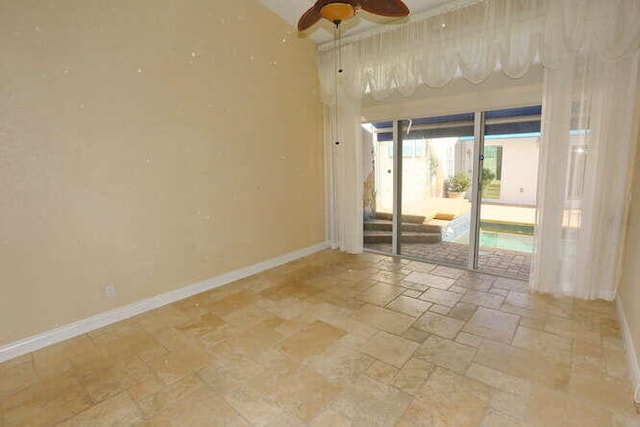 unfurnished room with ceiling fan and vaulted ceiling