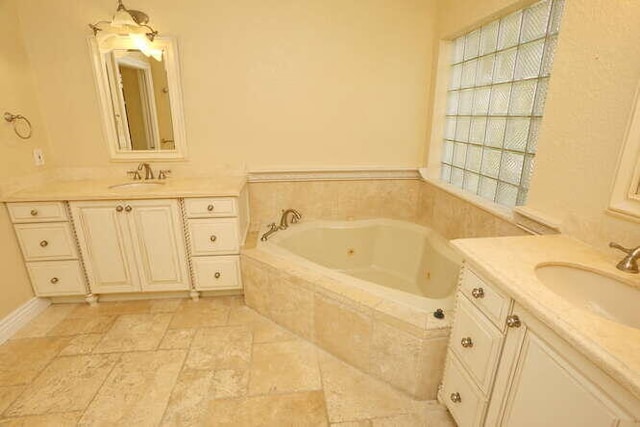 bathroom with vanity and a relaxing tiled tub