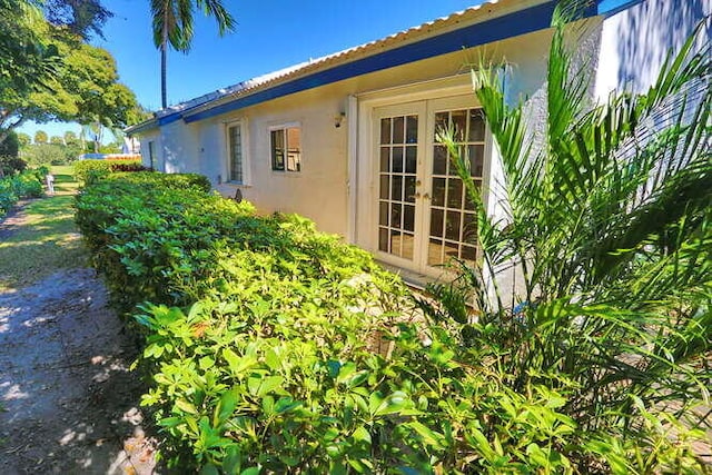 view of side of property featuring french doors